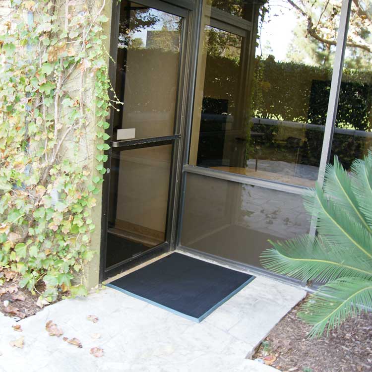 Door Scraper Action Shot 1 Large Doormat with blue border placed in front of door