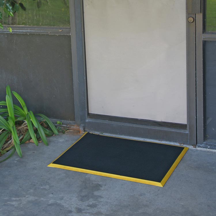 Door_Scraper_Action_Shot_3_Large Doormat with yellow border placed in front of door