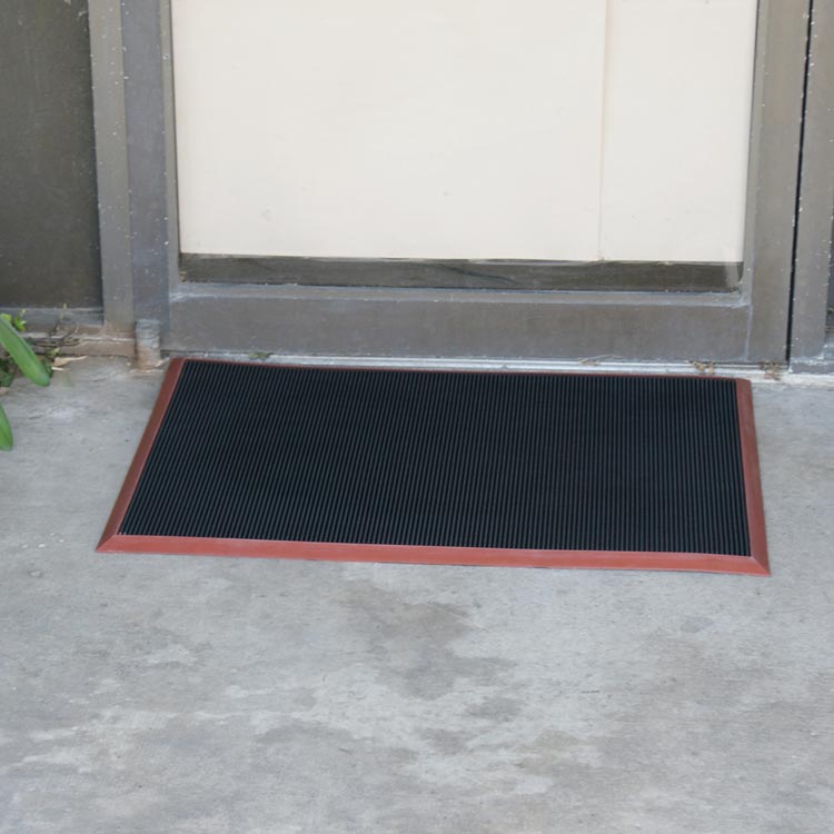 Door_Scraper_Action_Shot_4_Large Doormat with red border placed in front of door