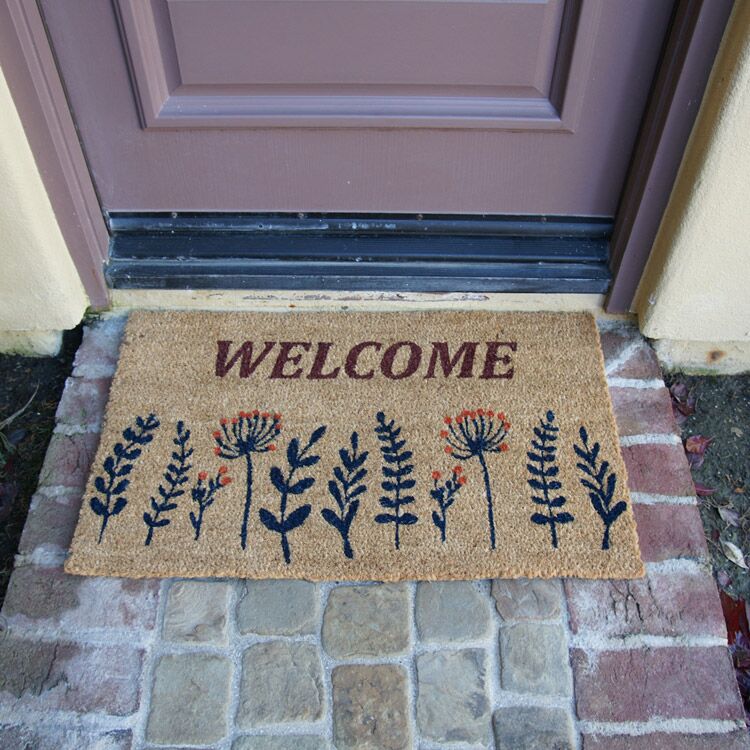 WildflowerMeadow Action 04 750x750 1 Wildflower Meadow Welcome Doormat in front of door