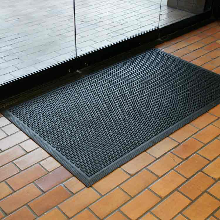 Dura_Scraper_Linear_Action1_Large Black color Ultra-Durable and Economical Rubber Doormat man standing