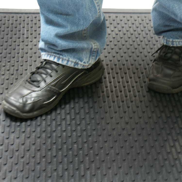 Dura_Scraper_Linear_Action3B_Large Black color Ultra-Durable and Economical Rubber Doormat man standing