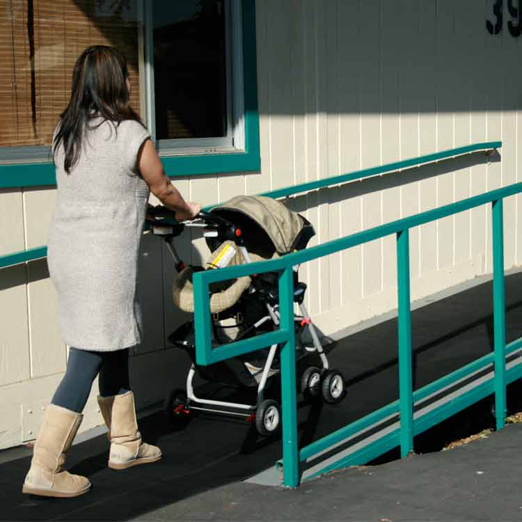 Ramp_Cleat_Action7_Large Woman moving a baby carriage up a ramp that has corrugated ramp cleat rubber runners