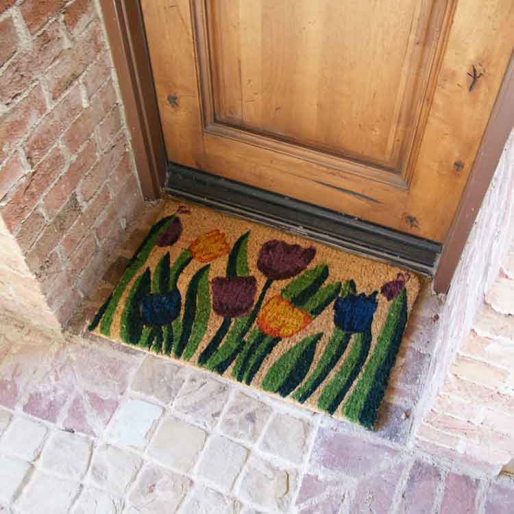 Tulip-02-Action_Large Handmade doormat with tulip garden design in front of light brown door