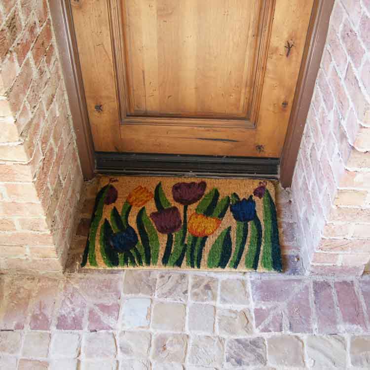 Tulip-03-Action_Large Handmade doormat with tulip garden design in front of light brown door