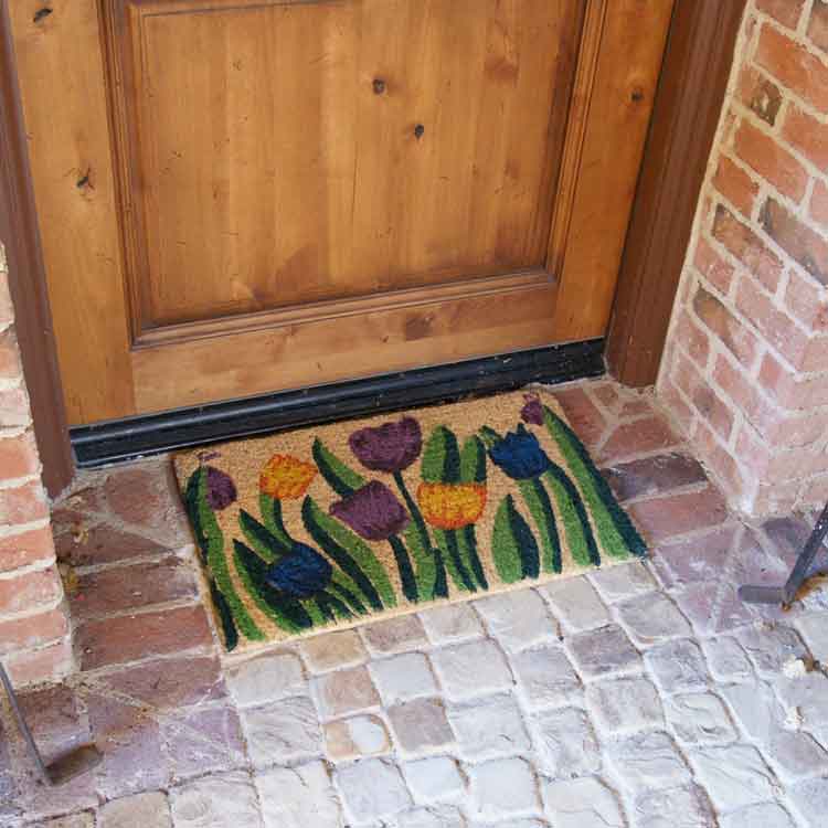 Tulip-06-Action_Large Handmade doormat with tulip garden design in front of light brown door