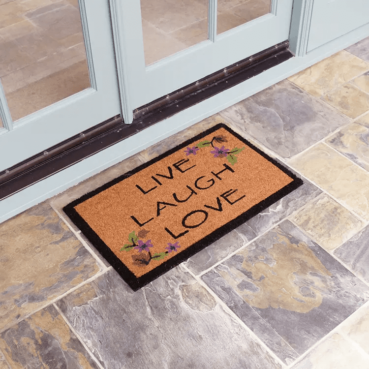 live-laugh-love-02-action_Large Brown live laugh love mat with black outline in front of white door tilted shot