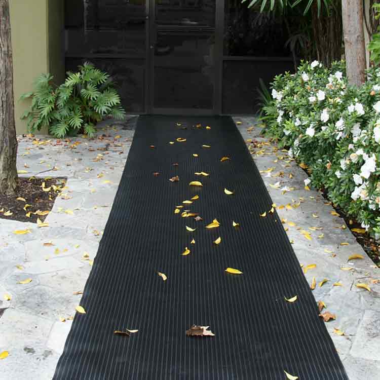 Composite Rib Action1 Angle1 Large Black Color Rubber Runner Mats with Extra Toehold in Wet Conditions placed on front porch