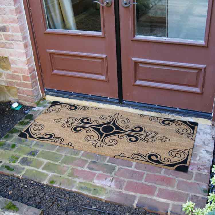 Traditional_Fleur_Action_02_Large Traditional Fleur de Lis French Mat in front of brown double door