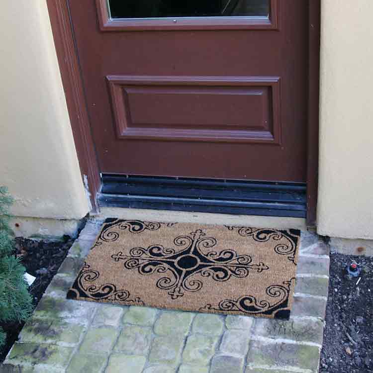 Traditional_Fleur_Small_Action_02_Large Traditional Fleur de Lis French Mat in front of brown door
